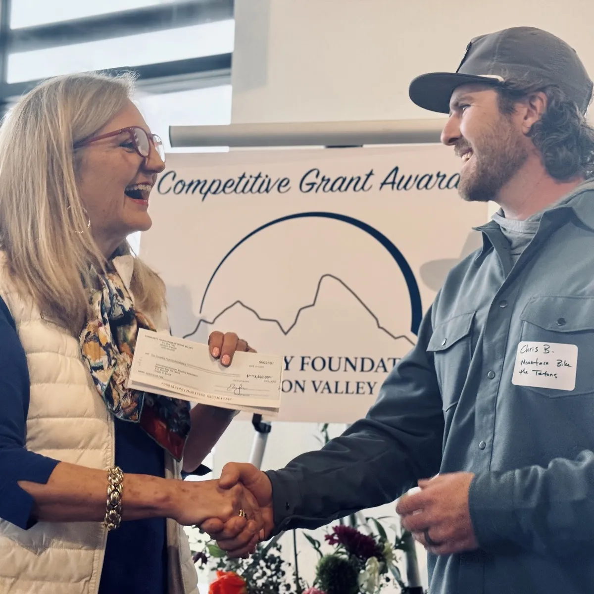 Community Foundation board member shaking hands with a grant recipient at the Competitive Grant Awards ceremony