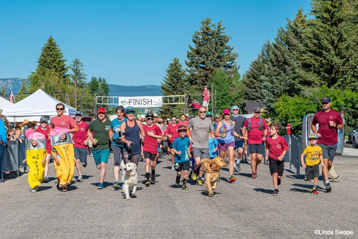 Participants and dogs at the start of the Tin Cup Challenge Fun Run in Teton Valley