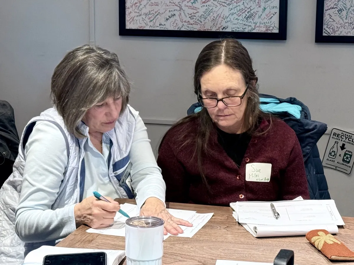 Two board members reviewing fund management documents at the Community Foundation office