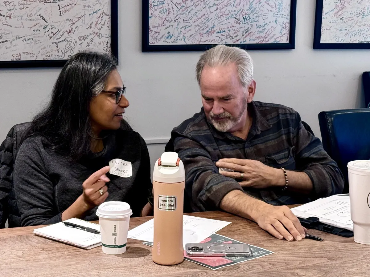 Two donors consulting together at a table in the Community Foundation office