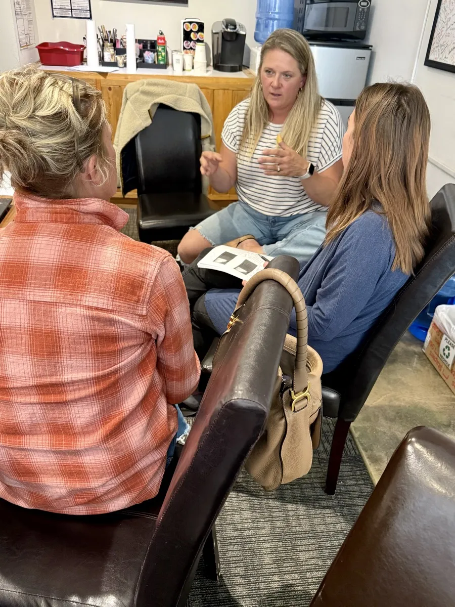 Three nonprofit leaders having an informal discussion at the Community Foundation office