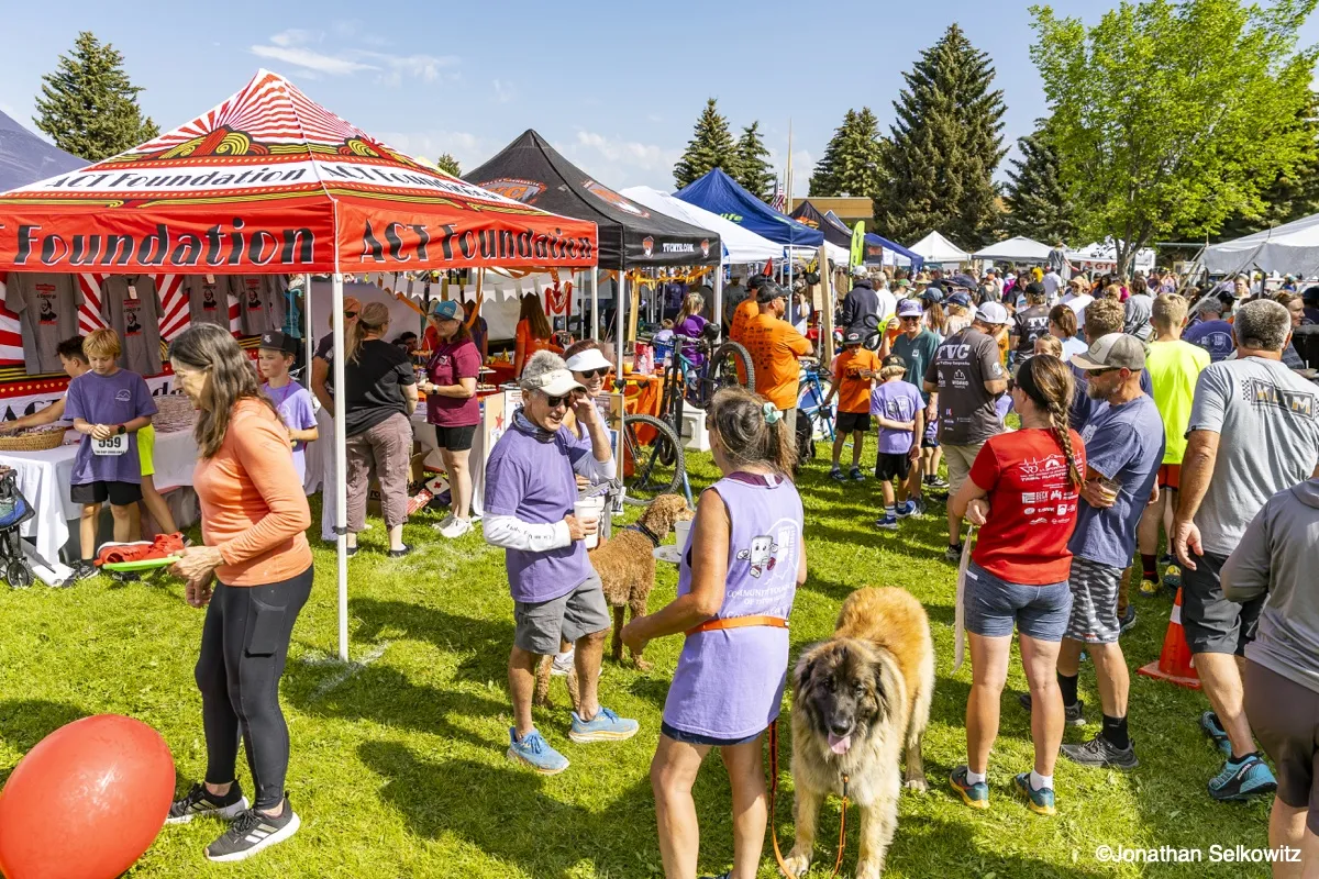 Community members and nonprofits with tents and booths at the Tin Cup Race Day event in Driggs